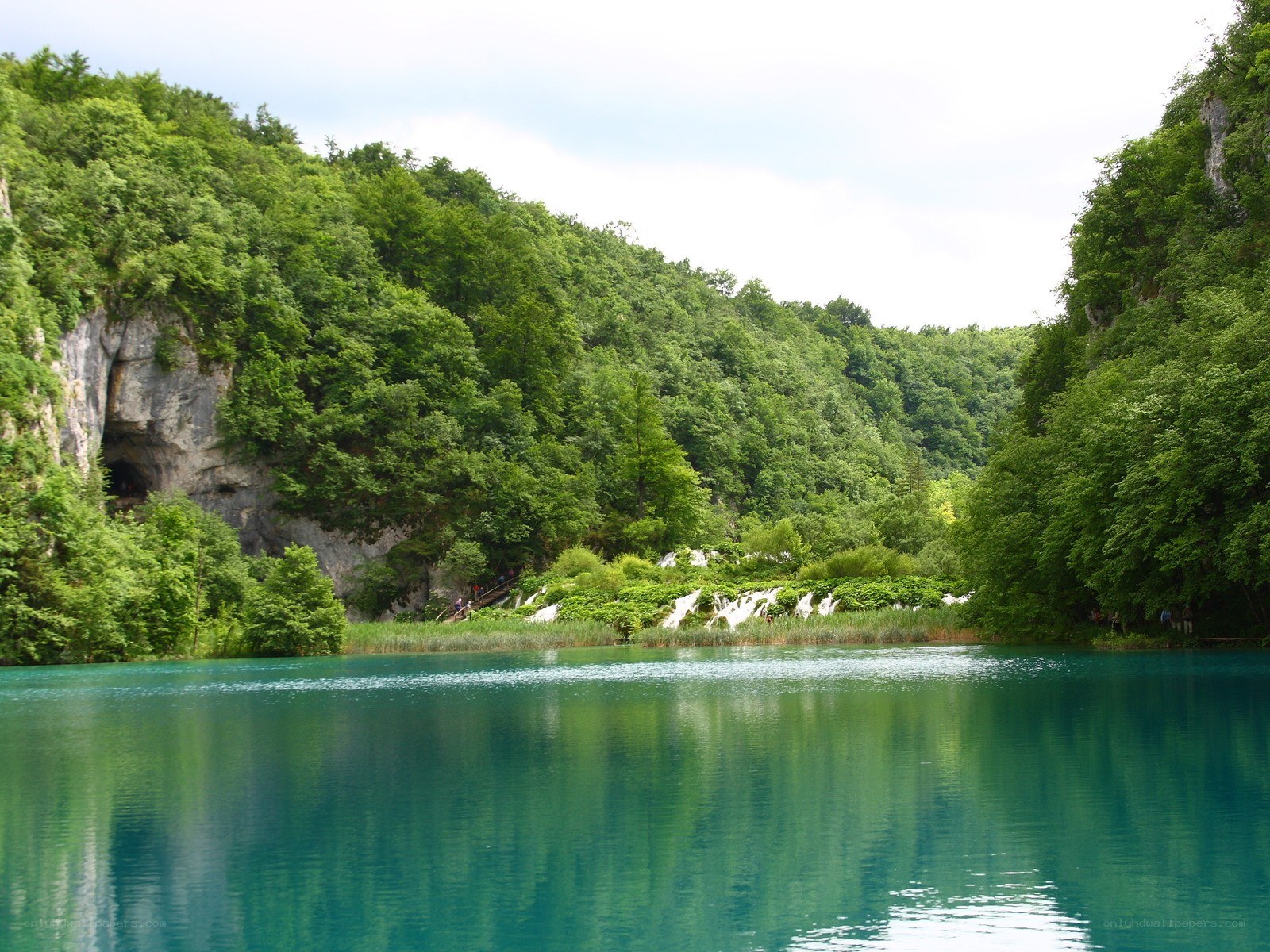 green lake with forested hills