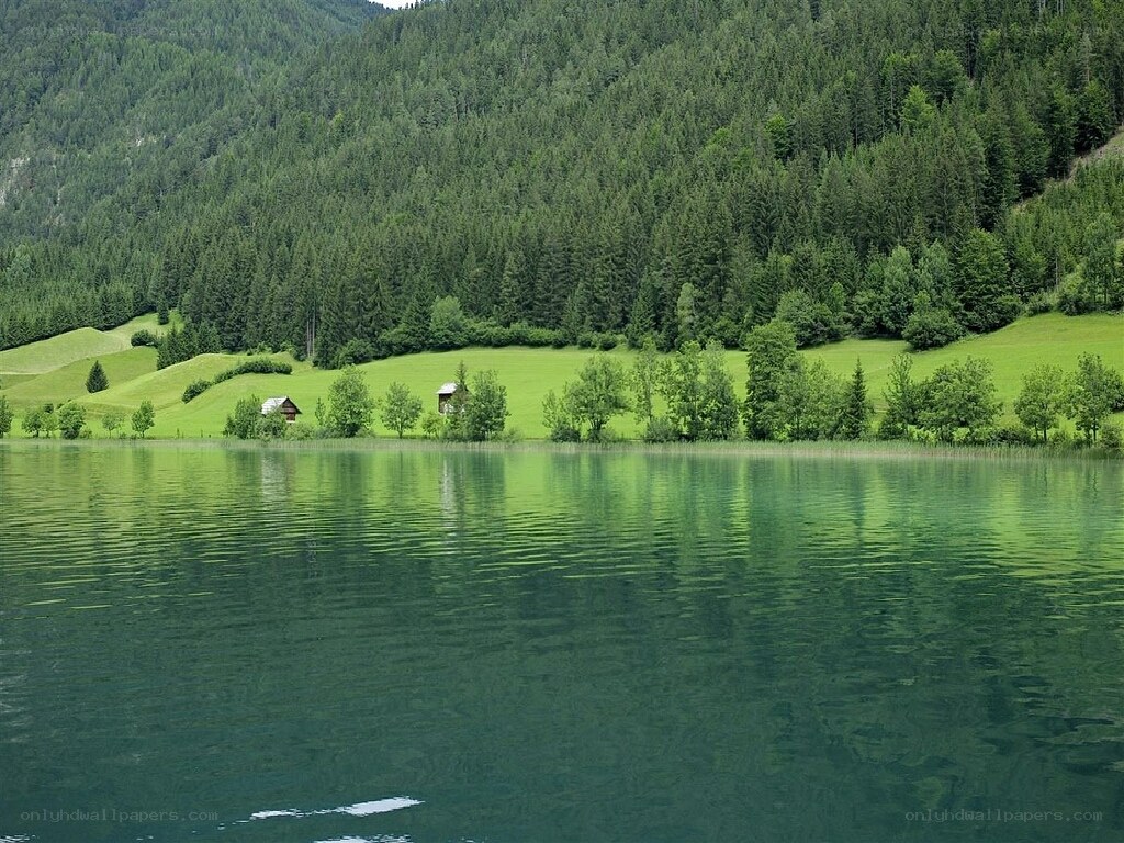 Green lake with forested hills