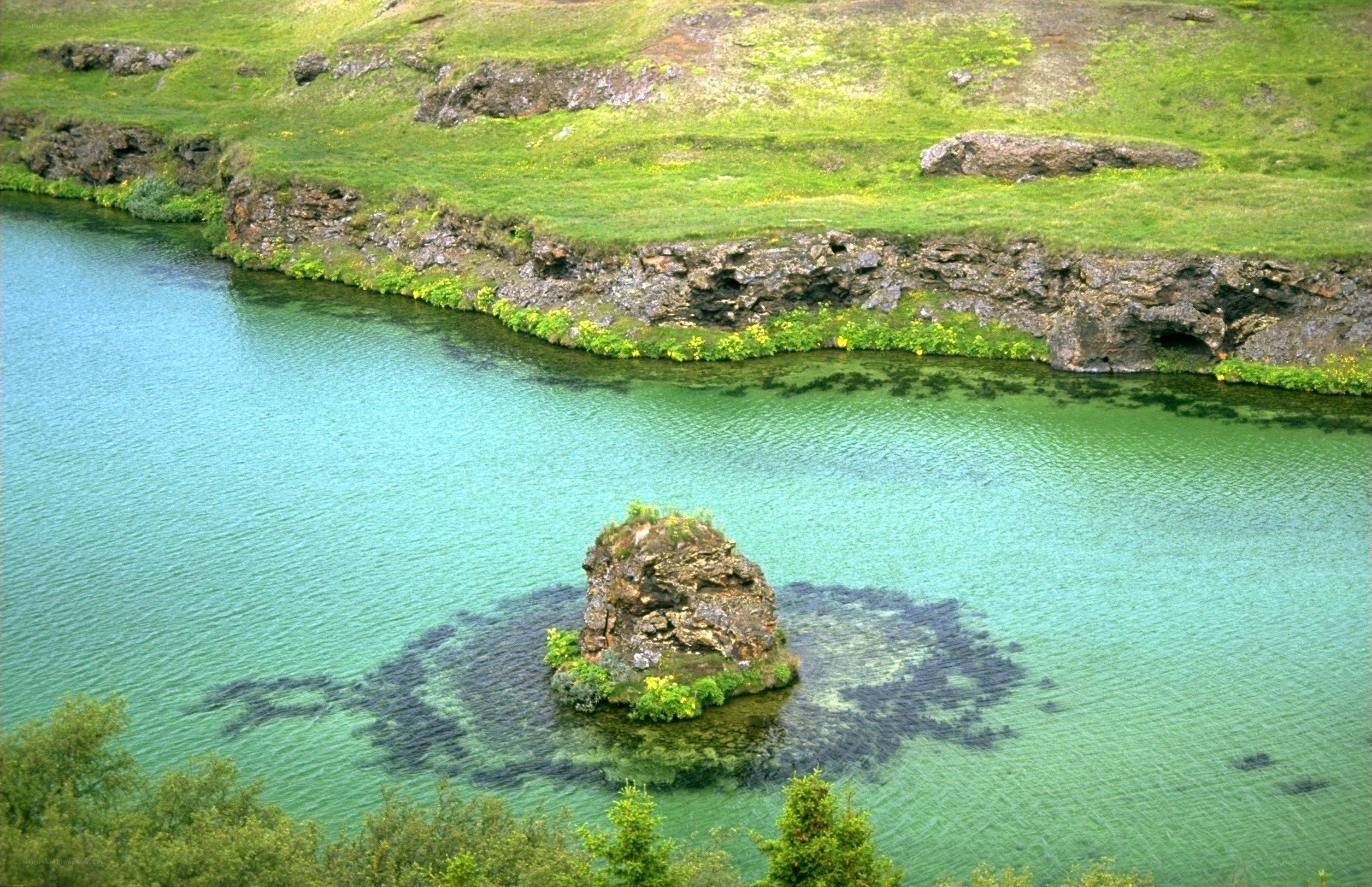 Green lake with rock island