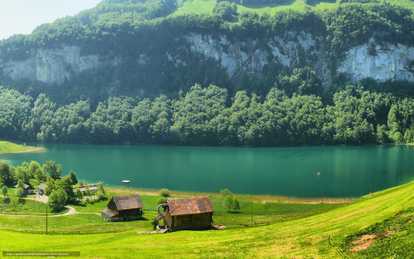 Green lake with wooden huts