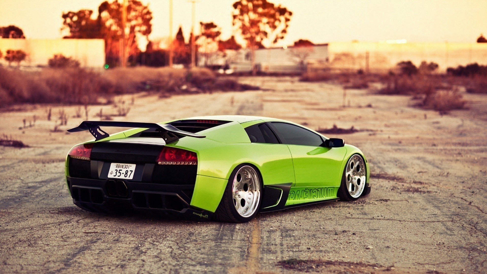 green lamborghini at sunset
