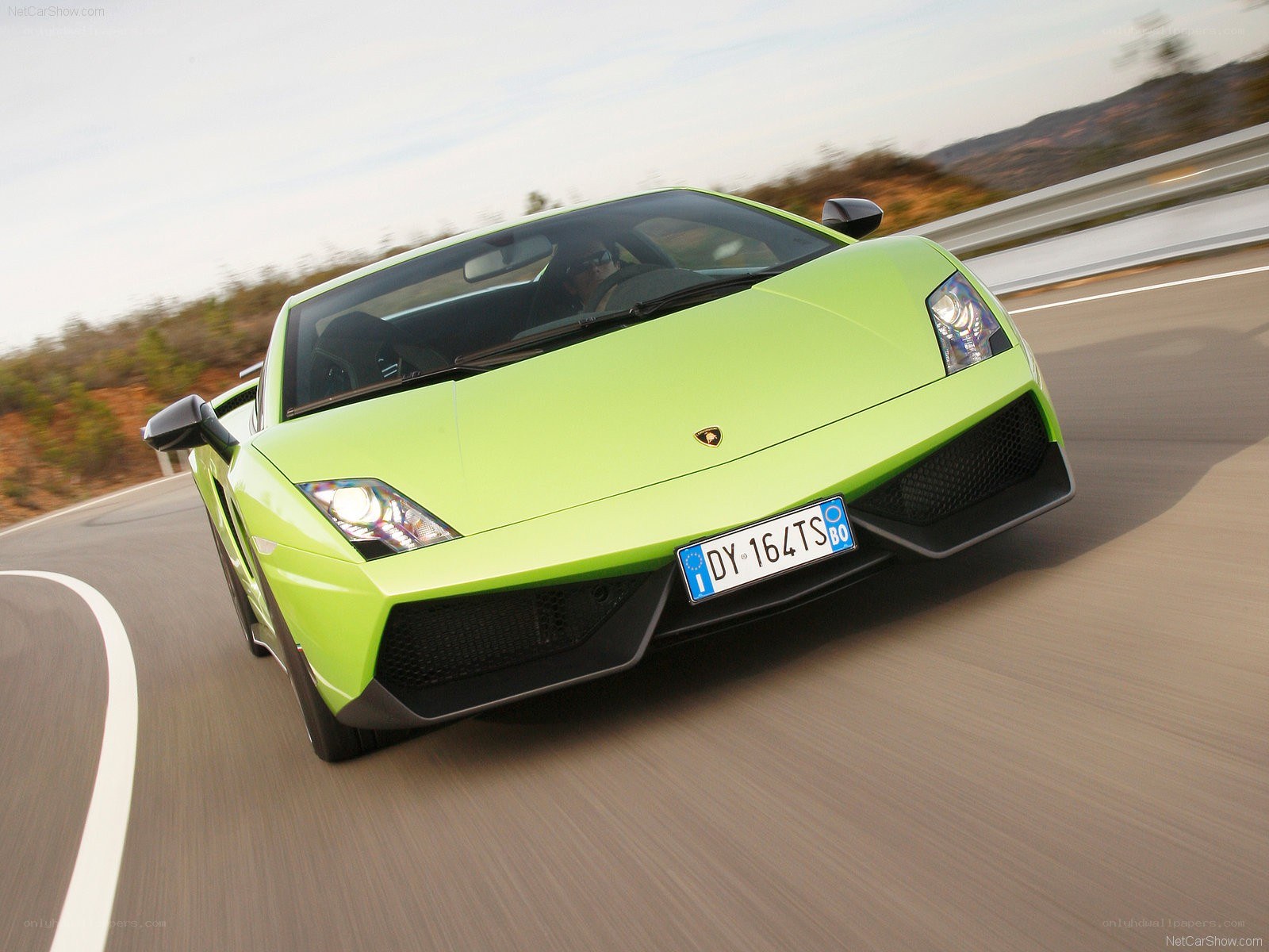 green lamborghini driving on road