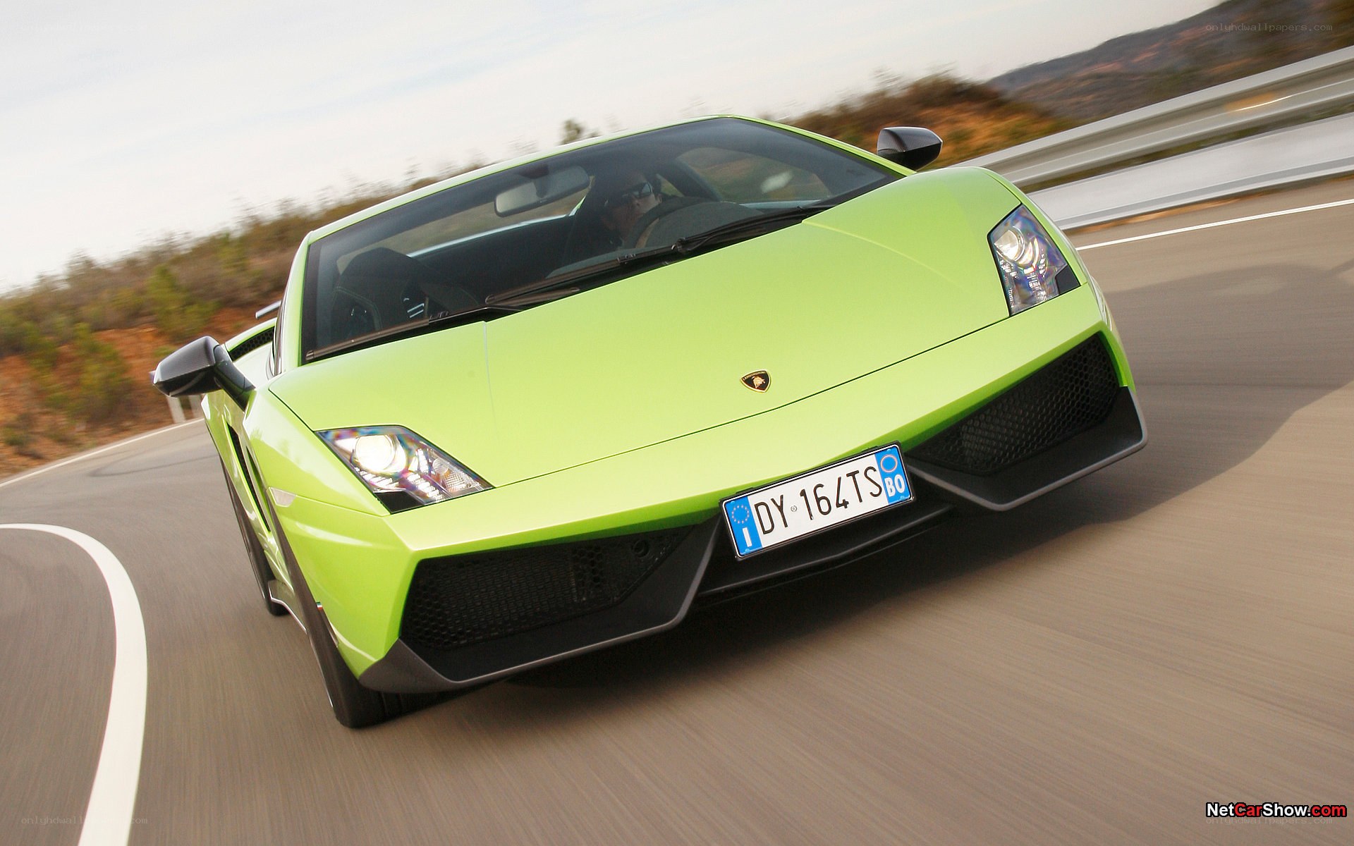 green lamborghini driving on road