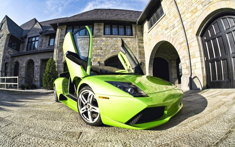 Green Lamborghini in front of mansion