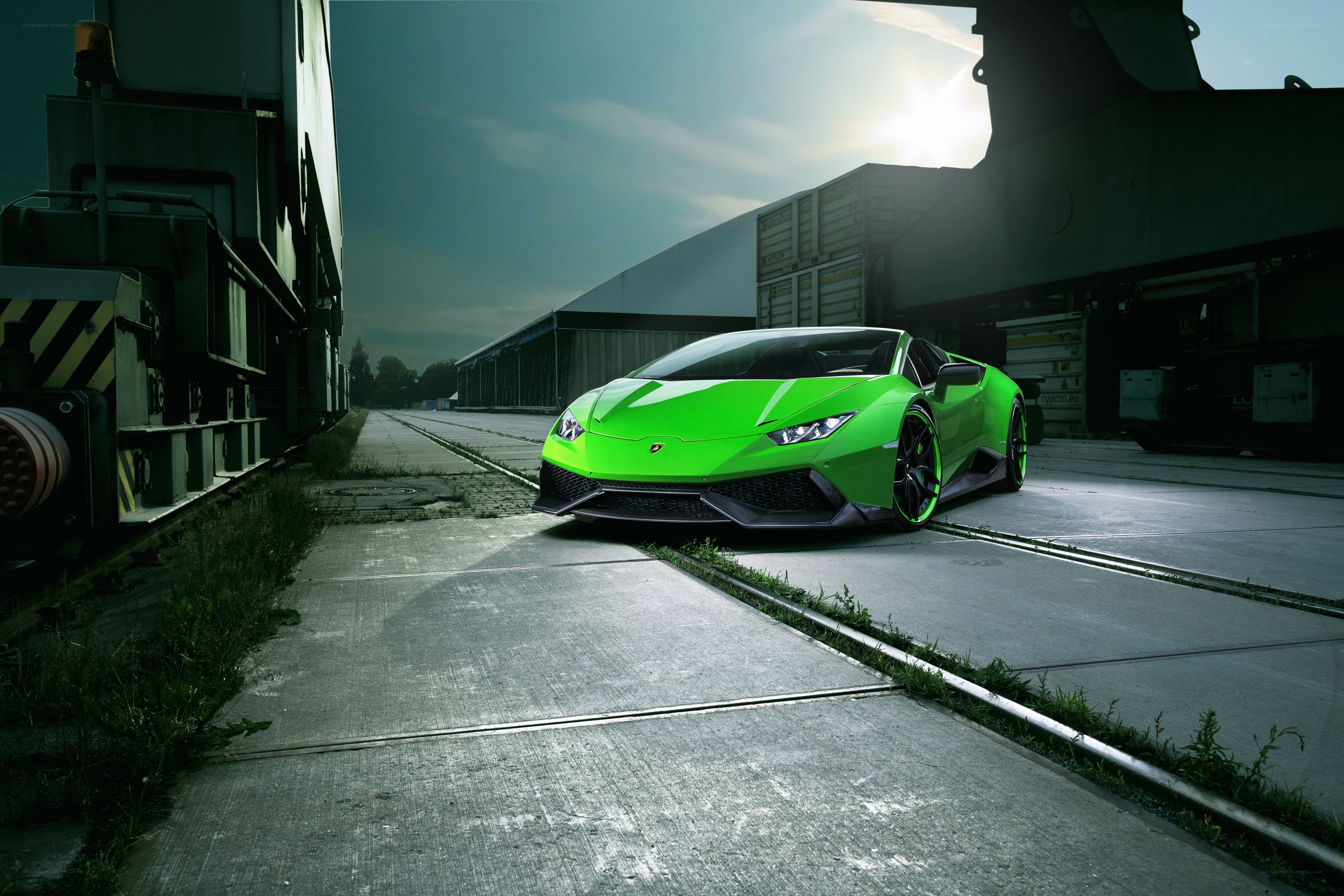 Green Lamborghini on train tracks