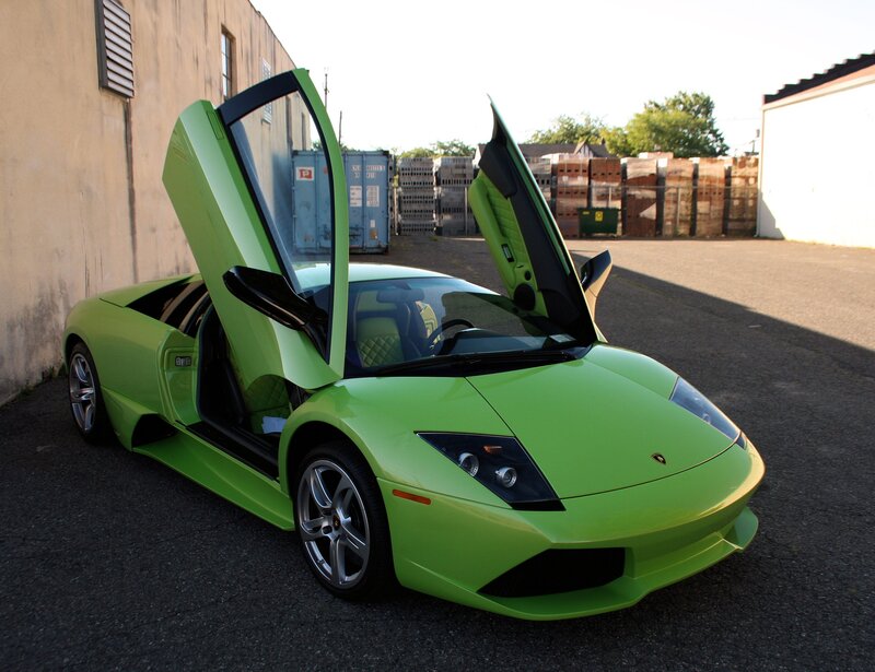 Green Lamborghini with doors open
