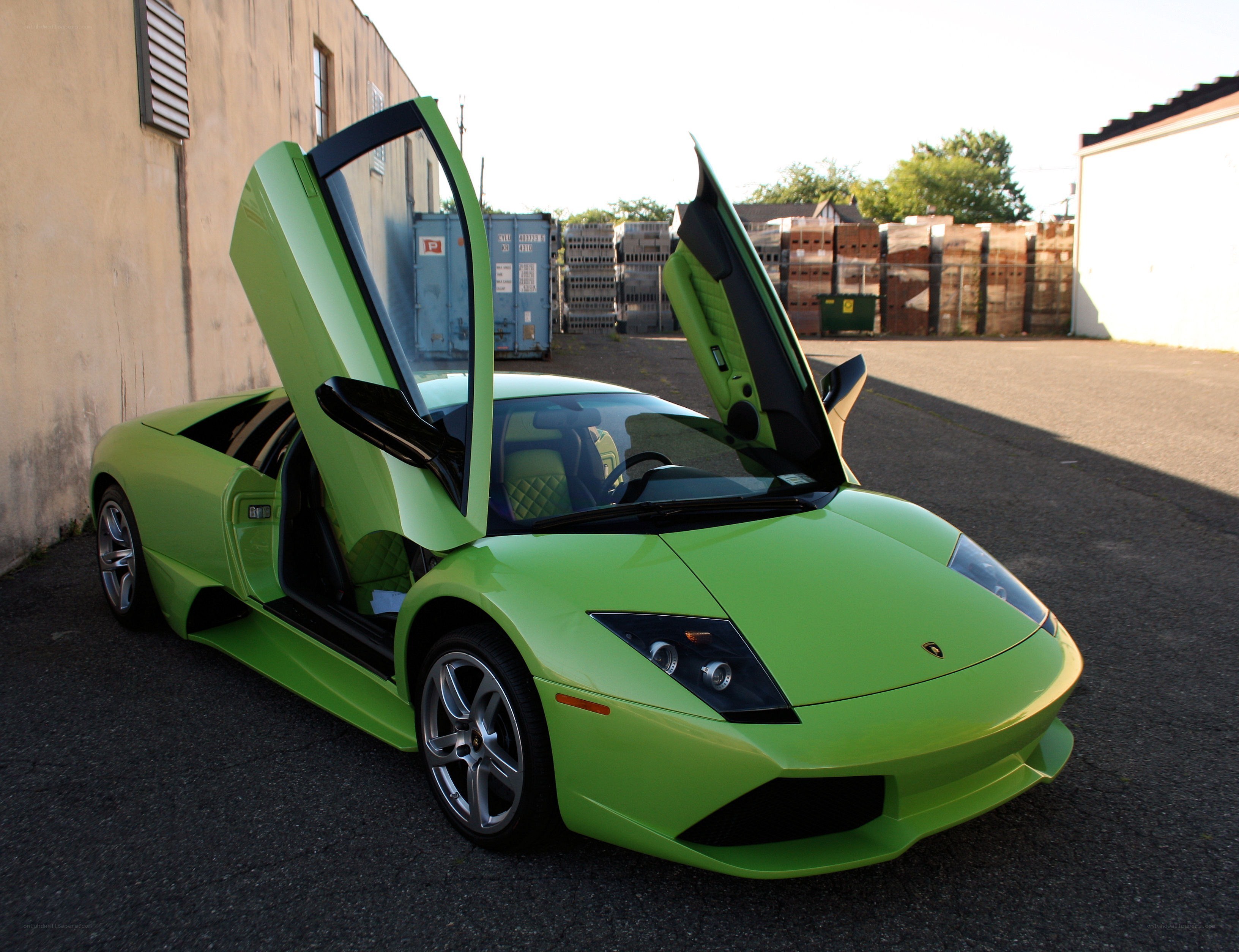 Green Lamborghini with doors open