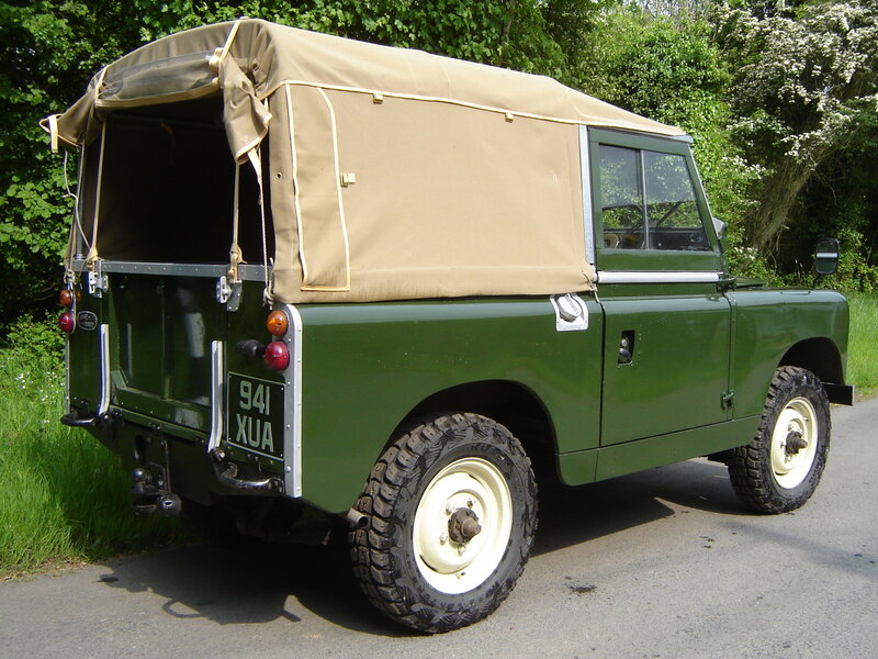 green land rover with canvas roof