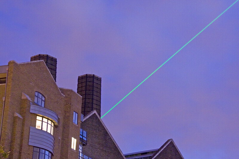 Green laser beam in the sky
