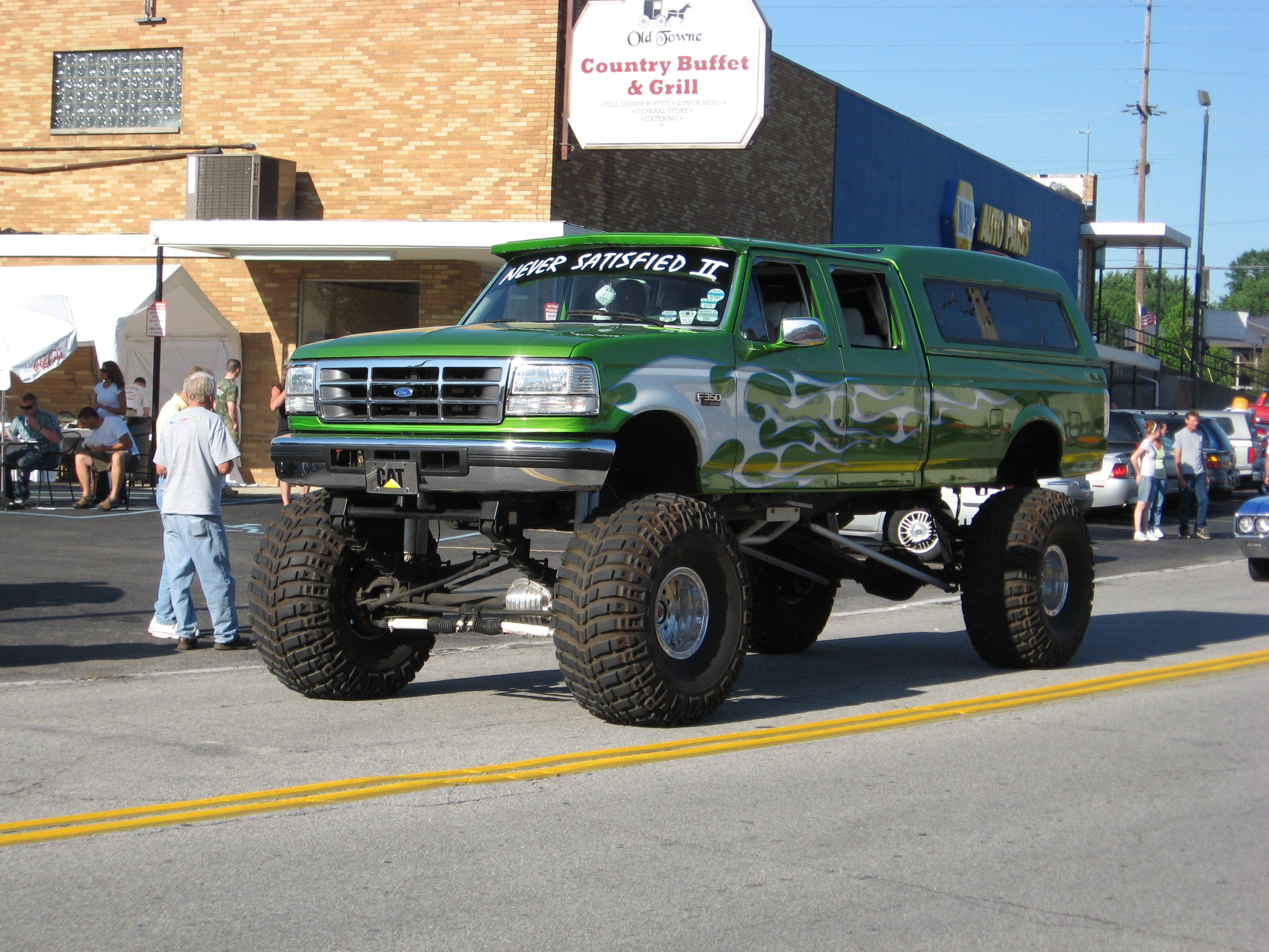 green lifted truck parade