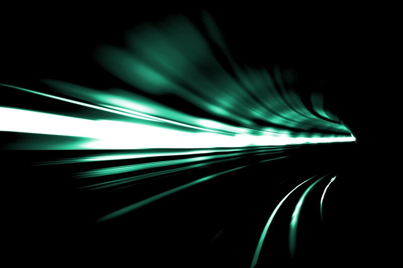 green light streaks in dark tunnel