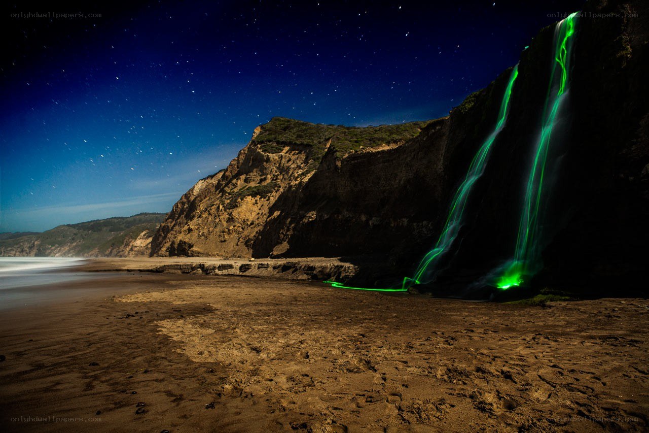 Green light waterfall at night