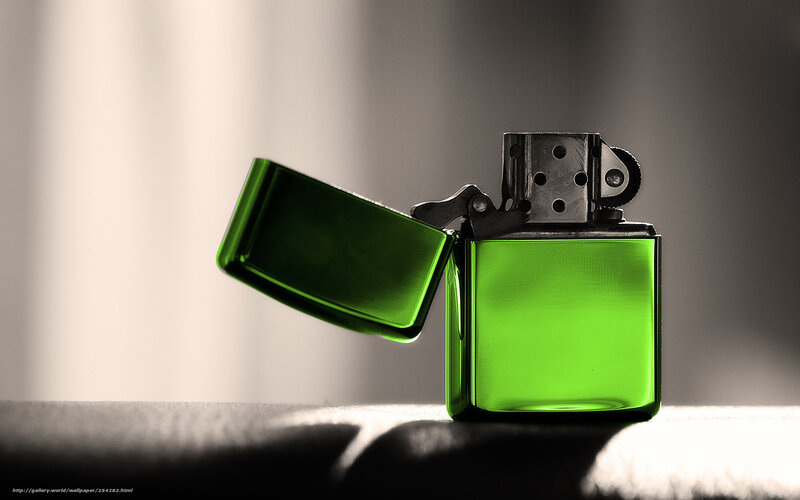 green lighter on dark surface