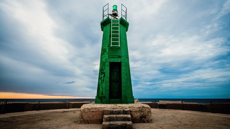 Green Lighthouse on Pier — Dramatic, Sunset