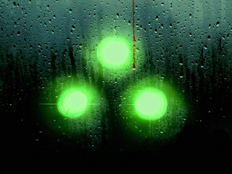 Green lights on rainy window