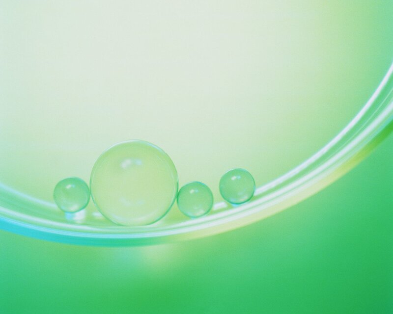 green liquid bubbles in a dish