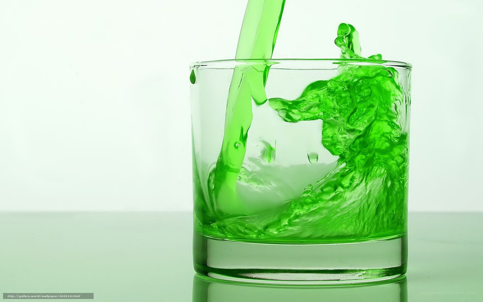 green liquid pouring into glass