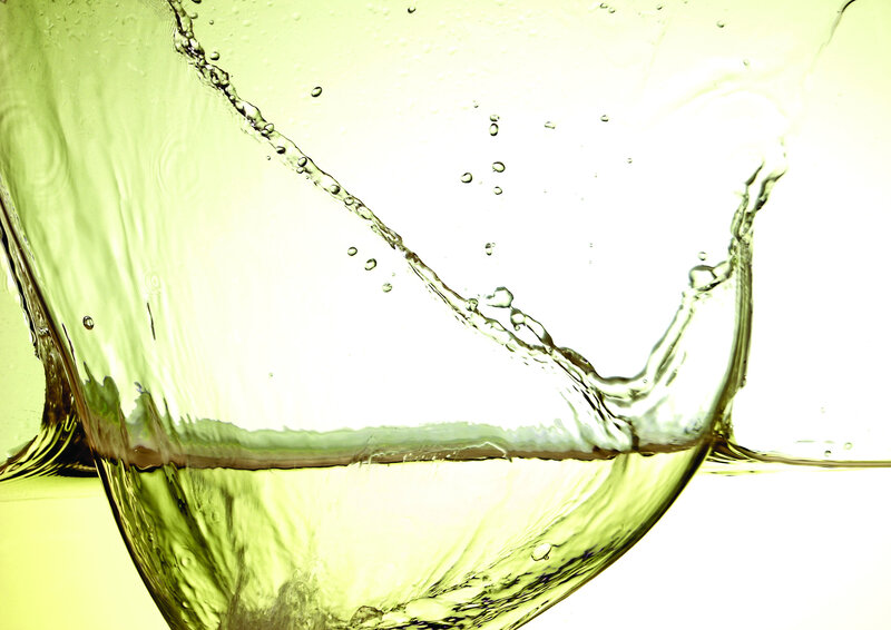 green liquid splashing in glass