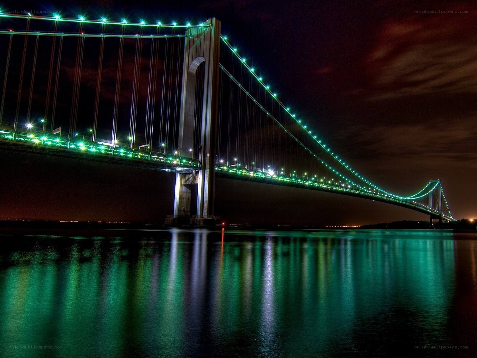Green-lit bridge at night