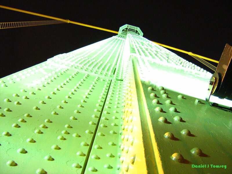 Green-lit bridge structure at night