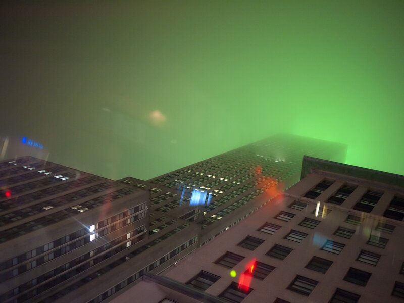 green-lit city skyline at night