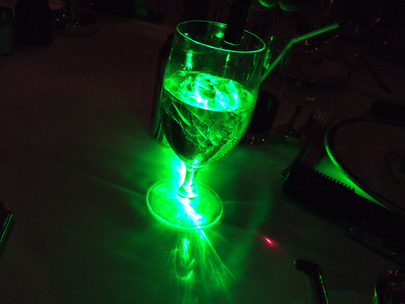 green-lit drink on table