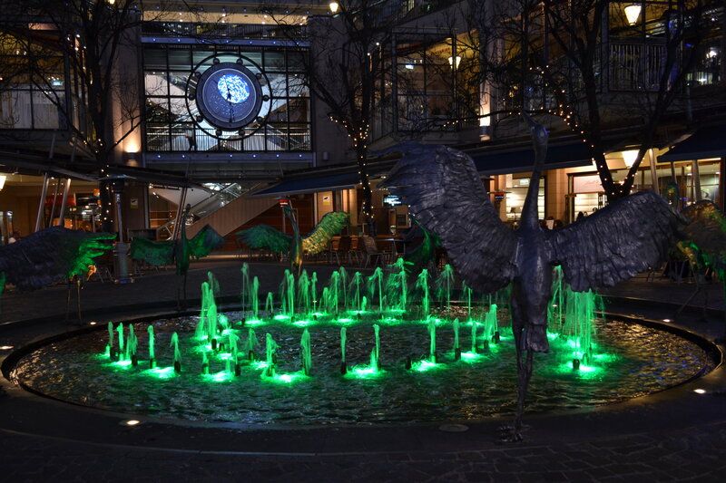 Green-lit Fountain with Bird Sculptures