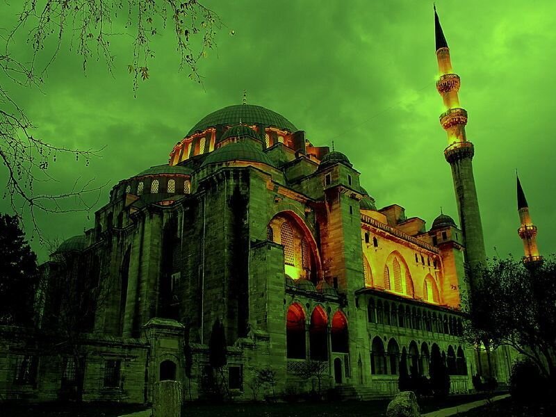 Green-lit mosque at night