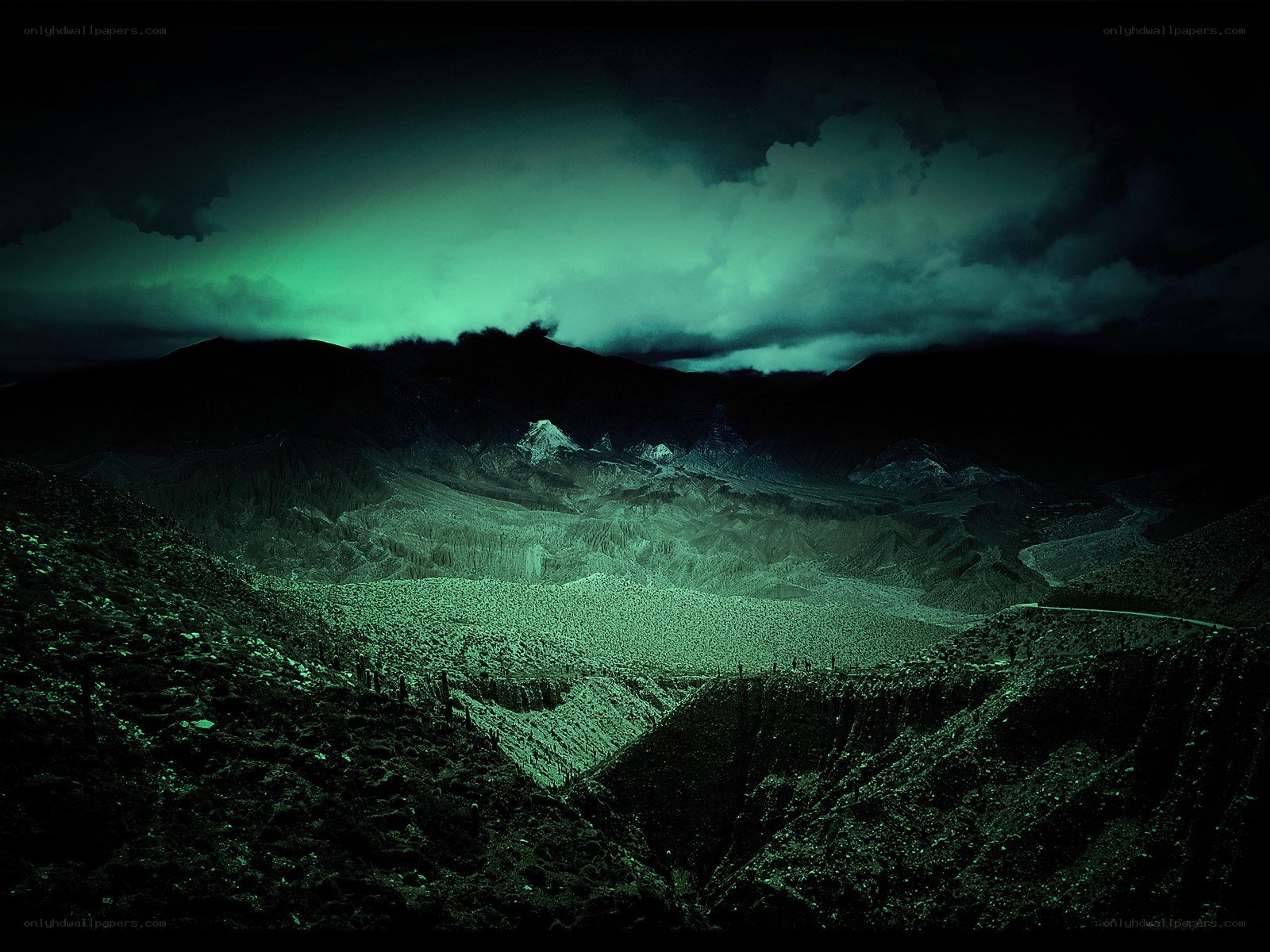 Green-lit mountain valley at night