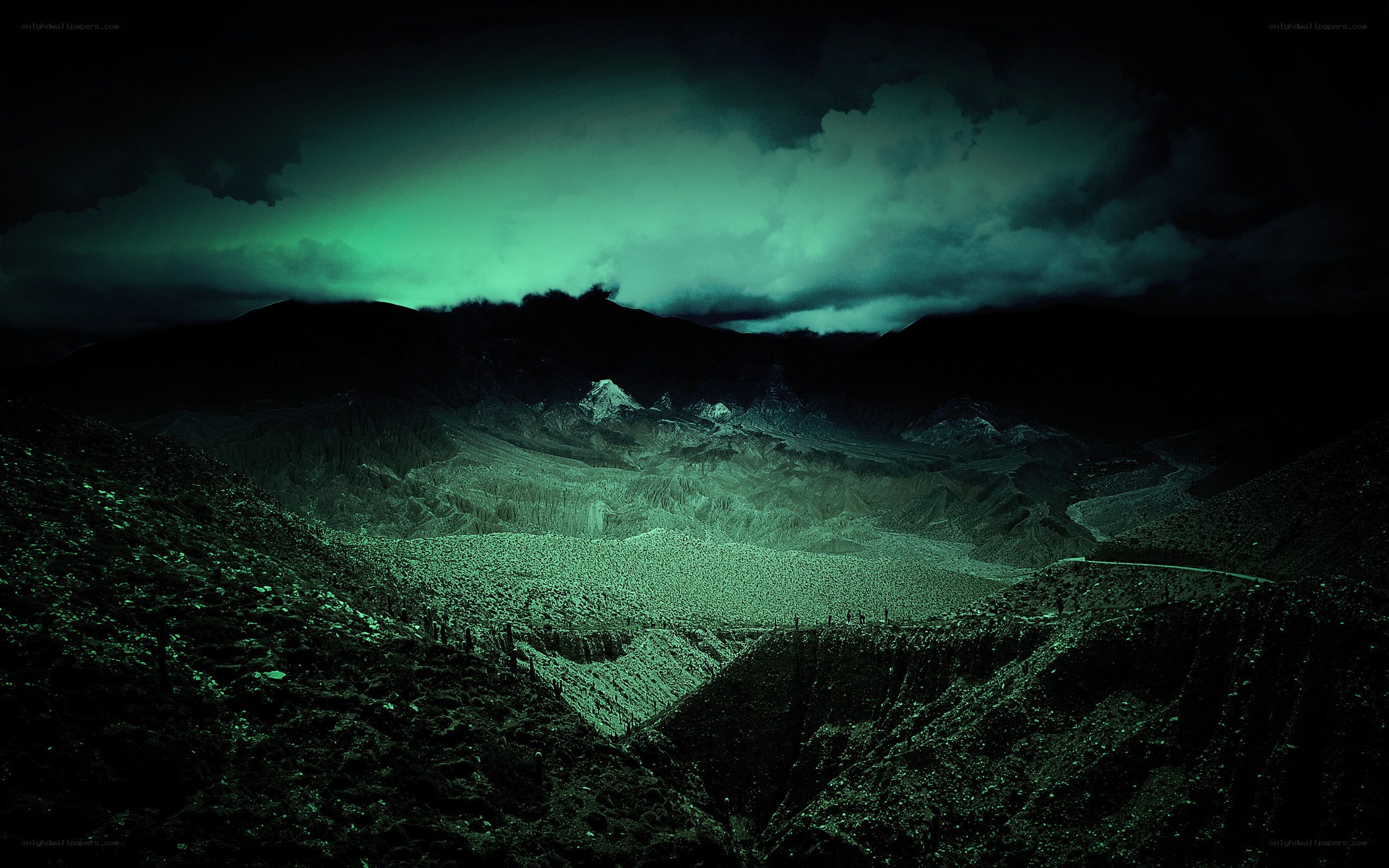 Green-lit mountain valley at night