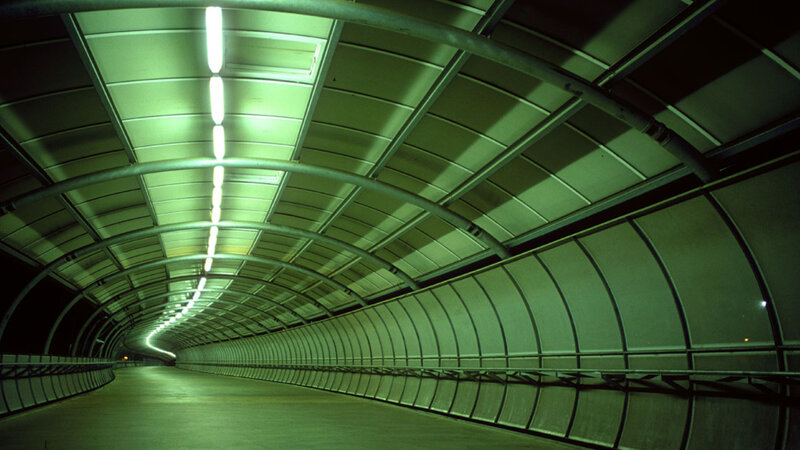 Green-lit tunnel corridor