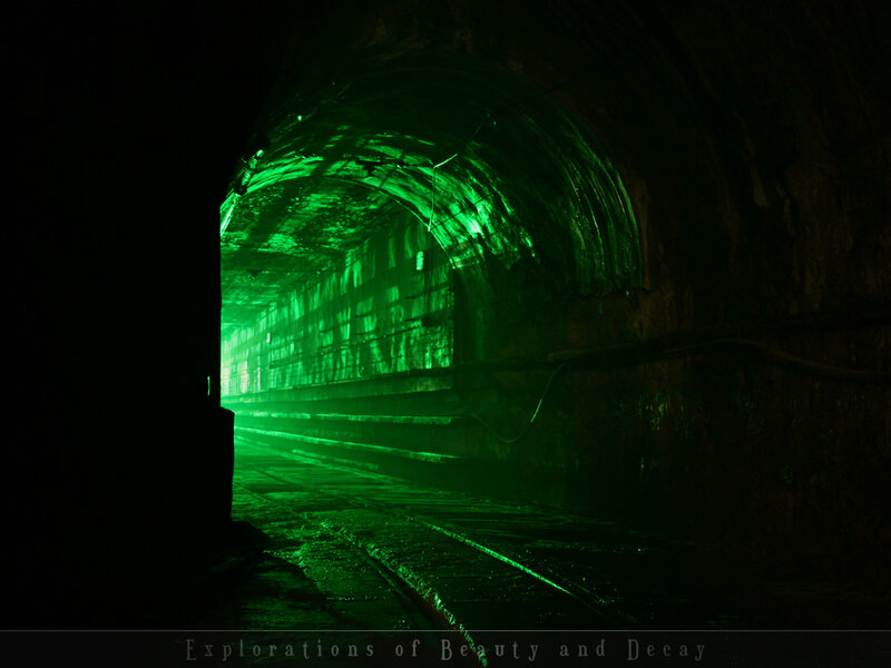 Green-lit tunnel corridor