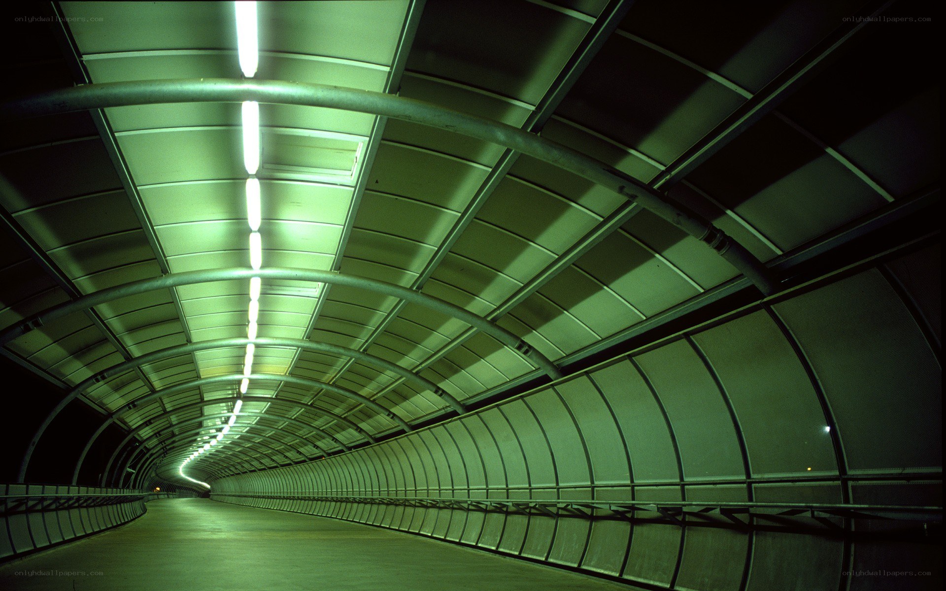 Green-lit tunnel corridor
