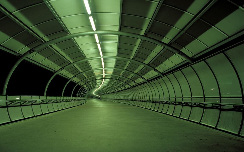 green-lit tunnel corridor