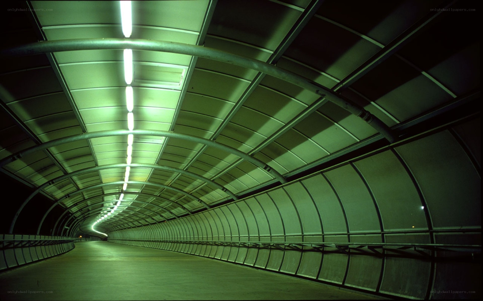 Green-lit tunnel corridor