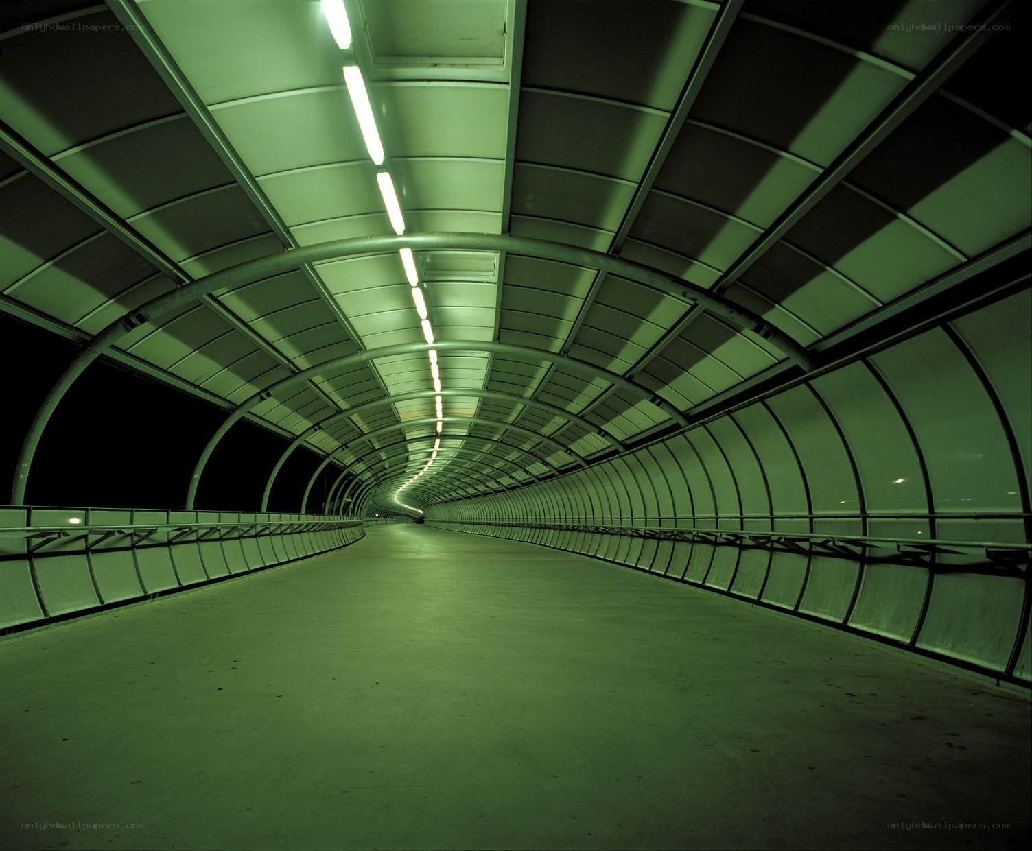 Green-lit tunnel walkway
