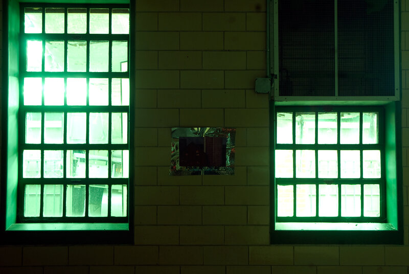 green-lit windows in a tiled room