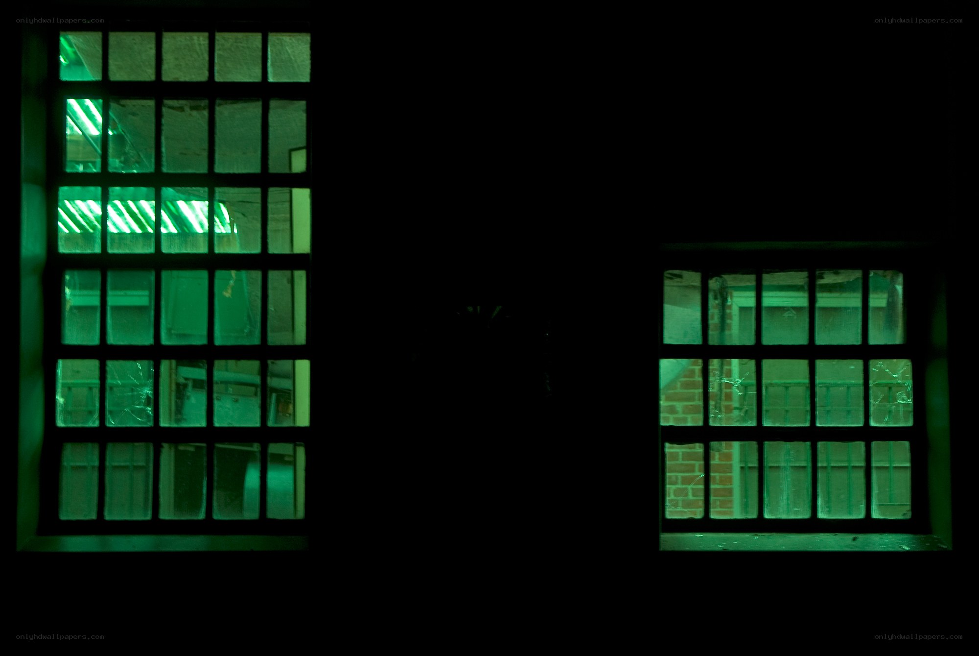 Green-lit windows in dark room