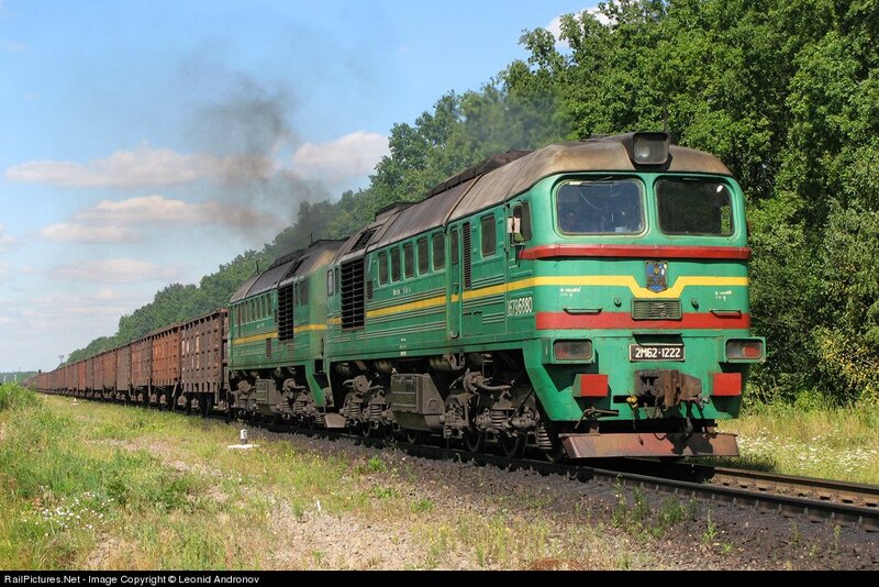 Green locomotive pulling freight train