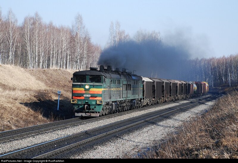 Green locomotive pulling freight train