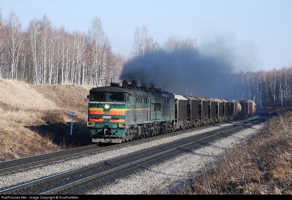Green locomotive pulling freight train