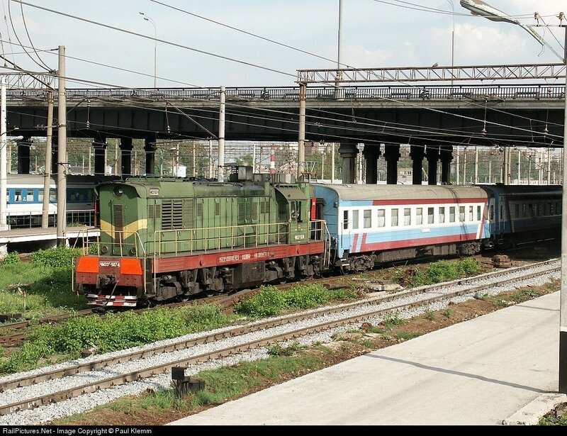 Green locomotive pulling train