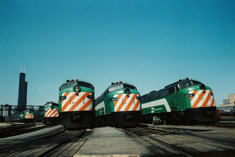 Green locomotives at a rail yard