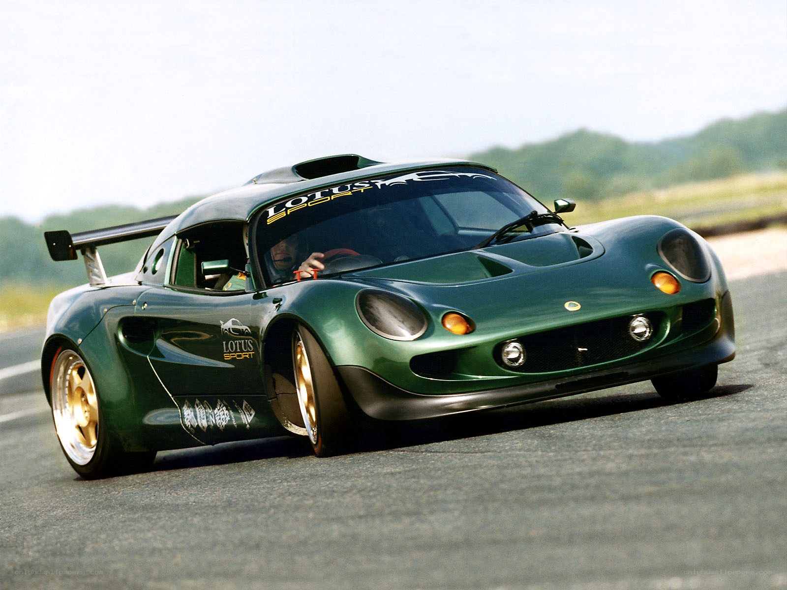 Green Lotus race car on track