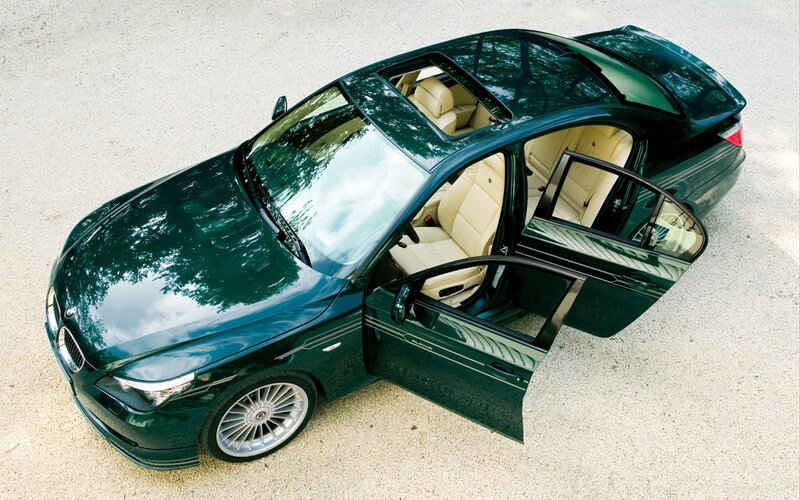 green luxury sedan with open doors