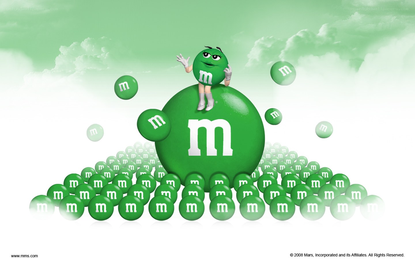 Green M&M character on a candy mound