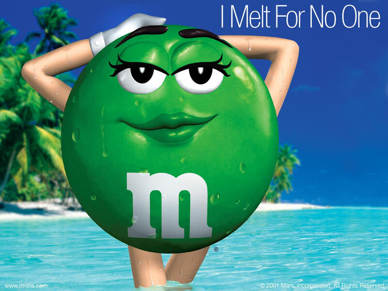 Green M&M on a beach