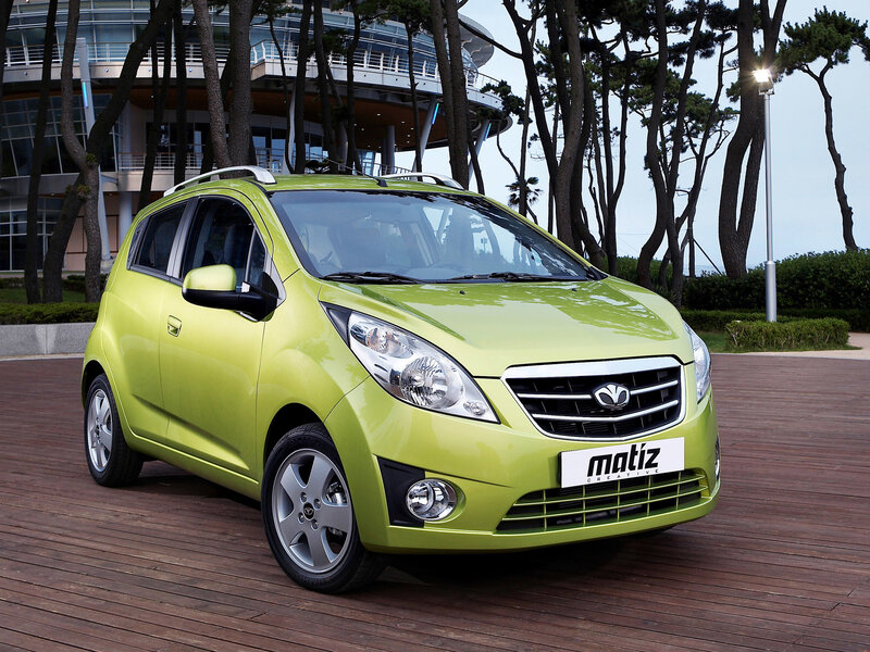Green Matiz car on wooden deck