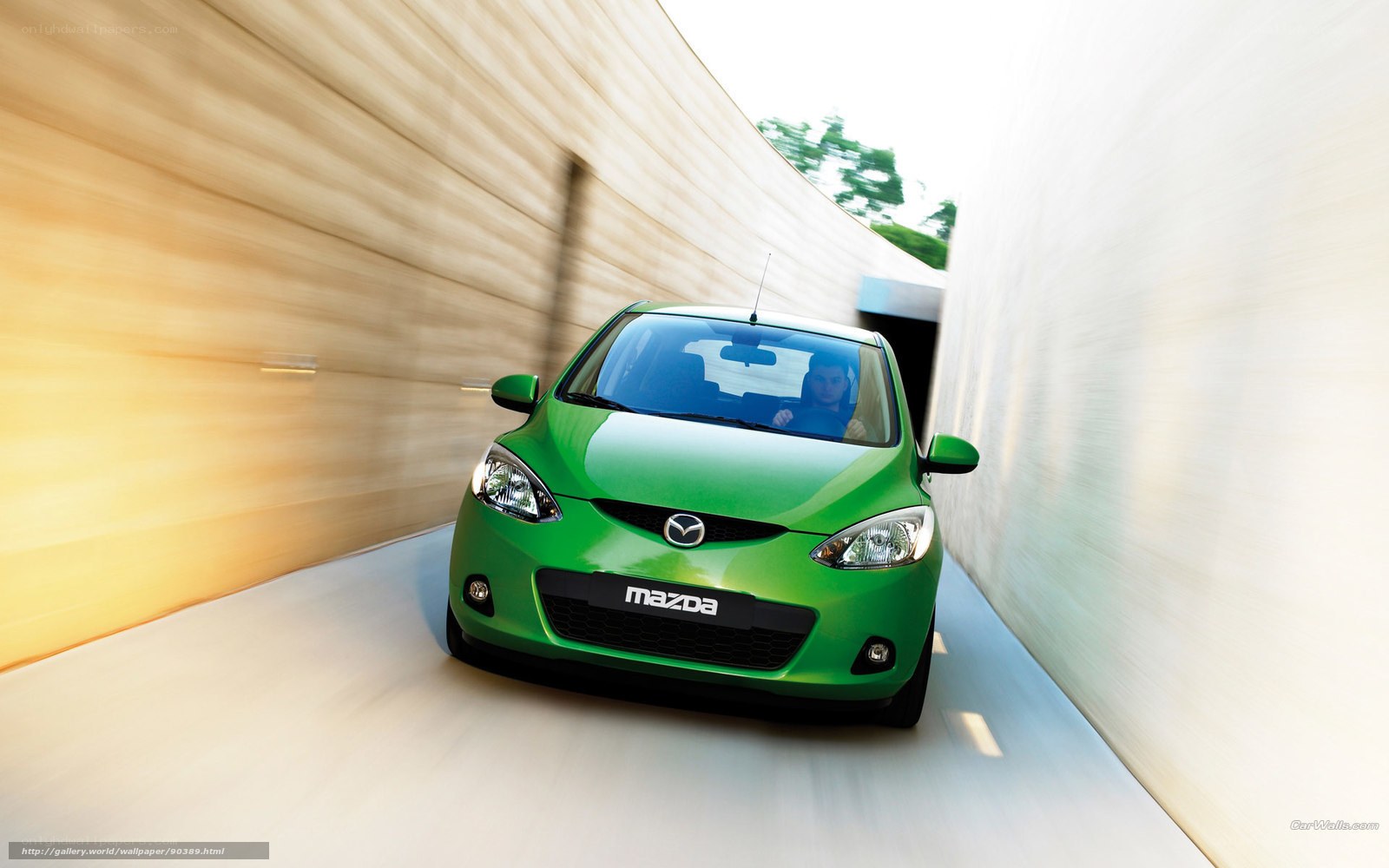 Green Mazda driving through tunnel