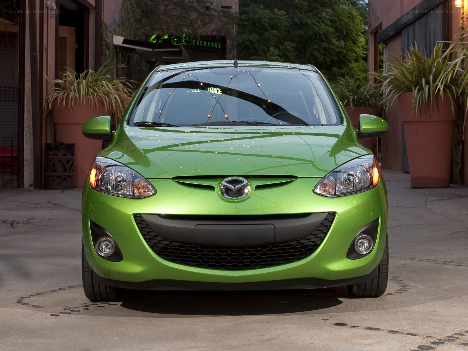 green mazda hatchback car